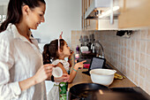 Mother and daughter in kitchen