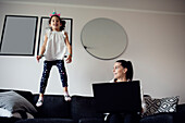 Mother and daughter on sofa