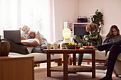 Family with children relaxing in living room