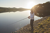 Person fishing at river