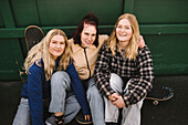 Portrait of teenage girls with skateboards