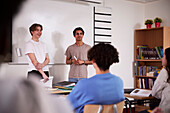 Teenage boys standing in classroom