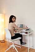Young woman working at desk at home