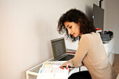 Young woman working at desk at home