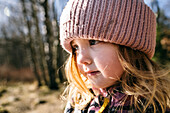 Close-up of girl in red knit hat