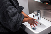 Mid section of woman washing hands