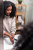 View of woman washing hands