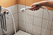 Hand holding shower head