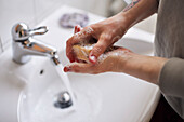 Close-up of man washing hands