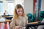 Teenage girl during keyboard lesson