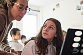 Teenage girl and teacher during keyboard lesson