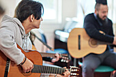 Teenage boy attending guitar lesson