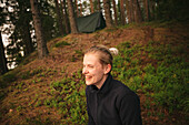Happy woman relaxing in forest