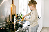 Boy preparing food in kitchen