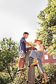 Child friends climbing net in park