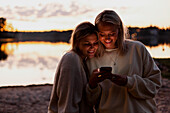 Female couple using cell phone