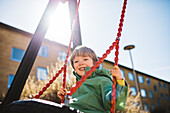 Smiling boy on swing