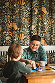 Mother with son doing craft