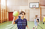 Children having PE class in school gym