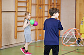 Children having PE class in school gym
