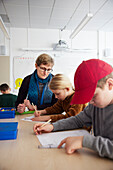 Teacher supervising students in classroom