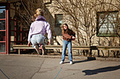 Girls jumping rope outdoors