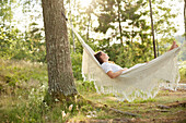 Woman relaxing in hammock