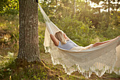 Woman relaxing in hammock