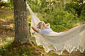 Woman relaxing in hammock