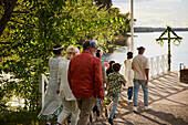 Family walking on jetty by lake