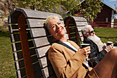 Mature woman relaxing on bench