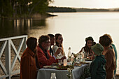 Family having meal at lake