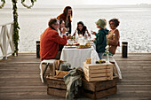 Family having lunch on pier