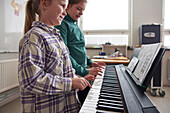 Girls playing keyboard instrument
