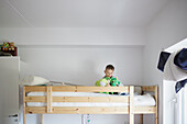 Boy playing in bunk bed