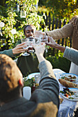 Hands with wineglasses toasting