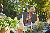 Smiling man at table in garden