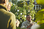 Smiling man at table in garden