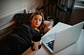 Girl at home using laptop