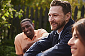 Smiling man sitting in garden