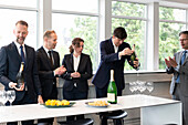 Business people celebrate with champagne