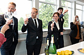 Business people celebrate with champagne