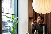 Woman in restaurant drinking wine