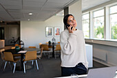 Woman using phone in office