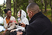 Friends drinking wine in forest