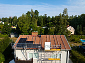 Männer bei der Installation von Solarzellen auf dem Dach