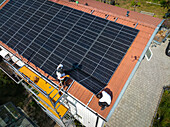 Installation of solar panels on roof of house
