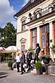 Business people leaving elegant restaurant