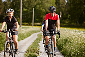 Smiling friends cycling together