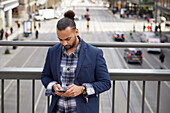 Smiling man using cell phone